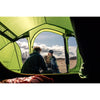 View from inside the bedroom - couple either side of a cookpot setup with one inside the tent, one out