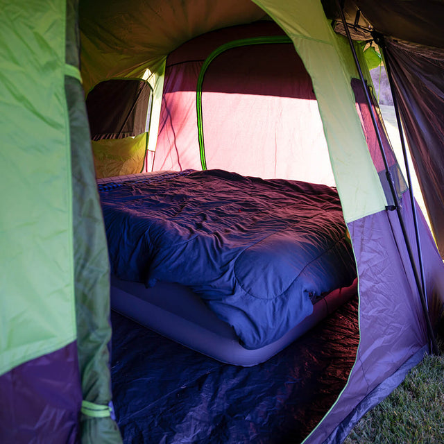 View of airbed set up in bedroom, looking through front door