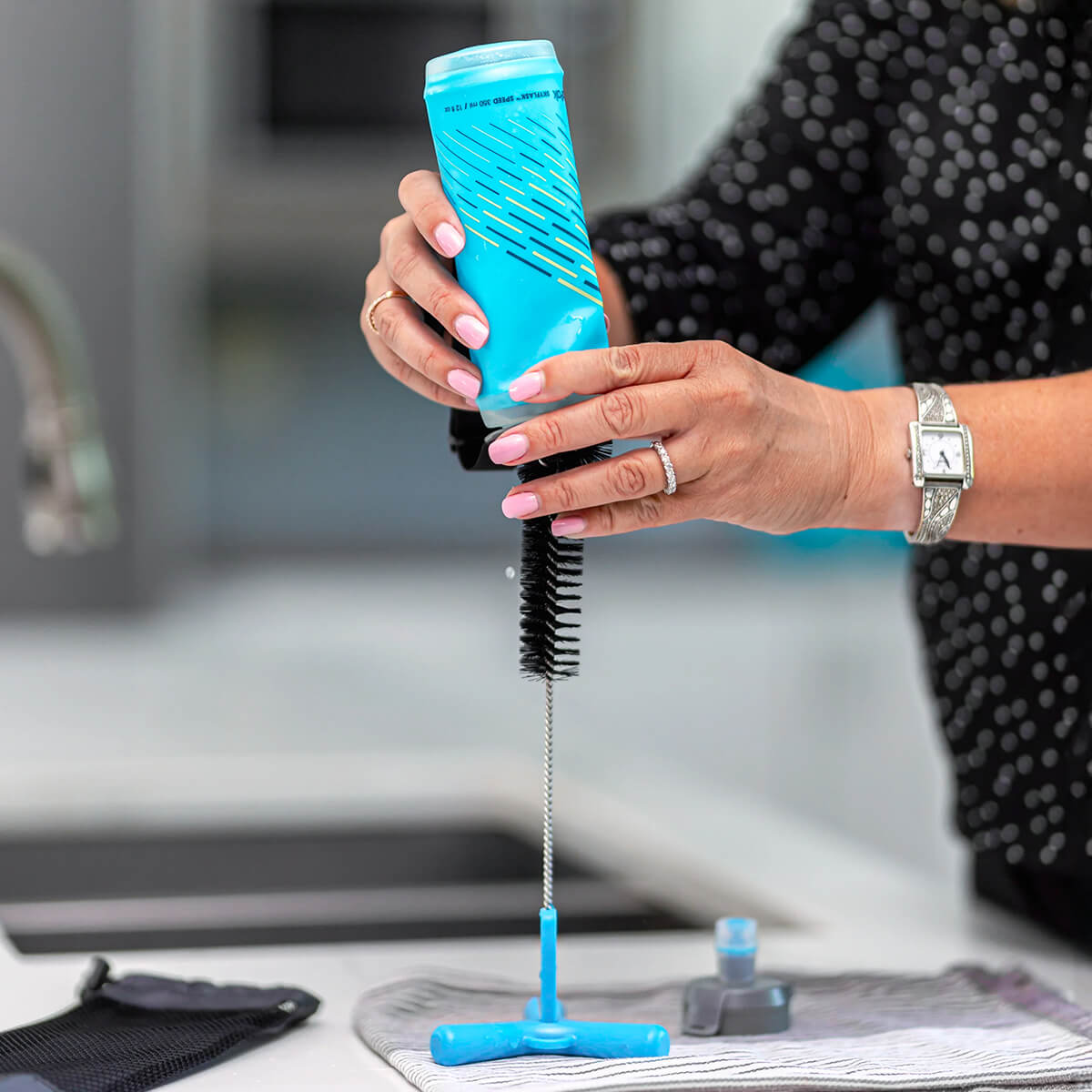 Bottle being put on drying on brush as drying stand