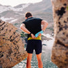 Being inserted into the back of a running belt in the mountains