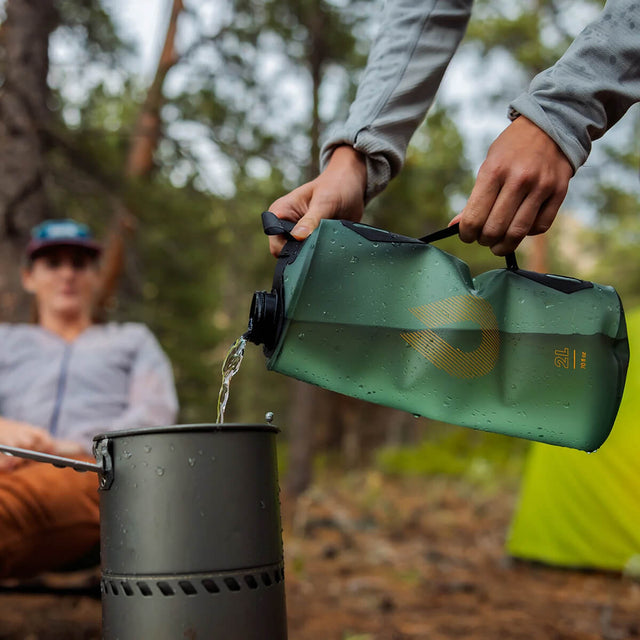 Sage Green, being used to fill a cooking pot