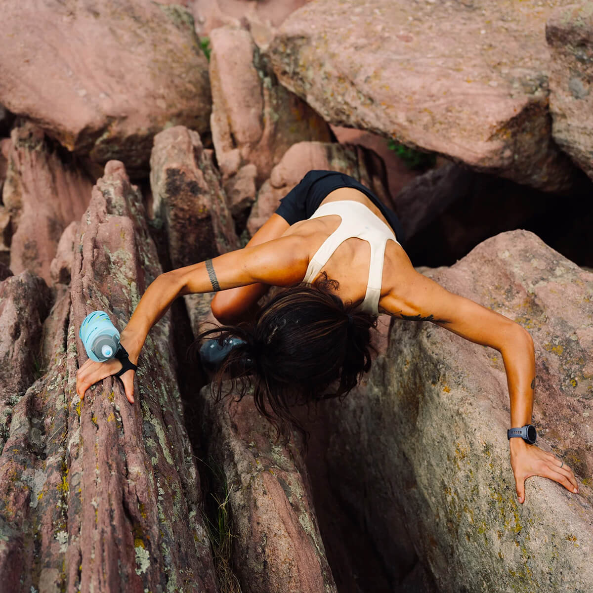 500ml version worn on back of hand of woman climbing rocks