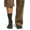 Dk Loden on model, front view, one trouser leg up, one down