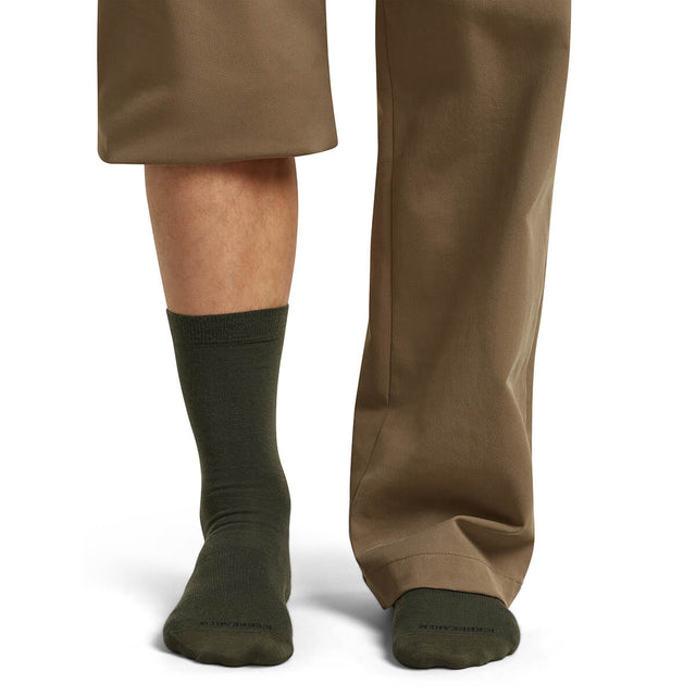 Dk Loden on model, front view, one trouser leg up, one down