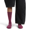 Dk Berry on model, front view, one trouser leg up, one down