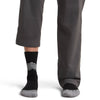 Black/Alloy/Snow on model, front view, one trouser leg up, one down