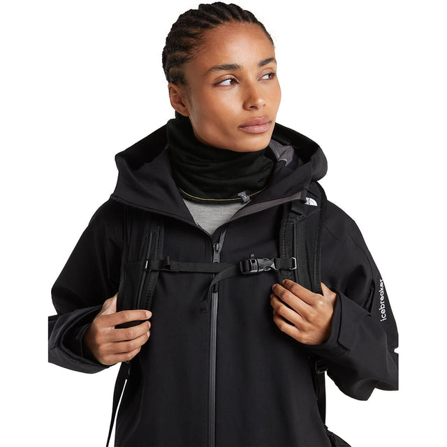 Black/Obsidian reversed, worn with jacket and pack by female model, front view