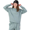 Storm blue on female model, adjusting beanie