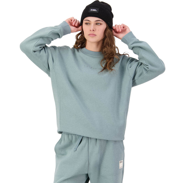 Storm blue on female model, adjusting beanie