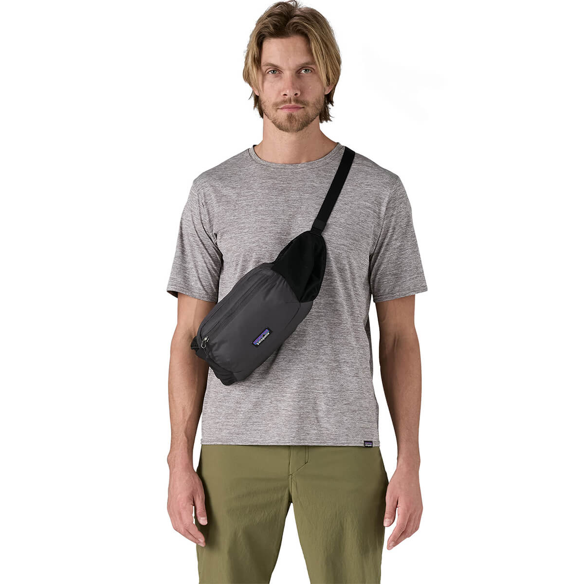 Black carried as a crossbody pack at front by male model