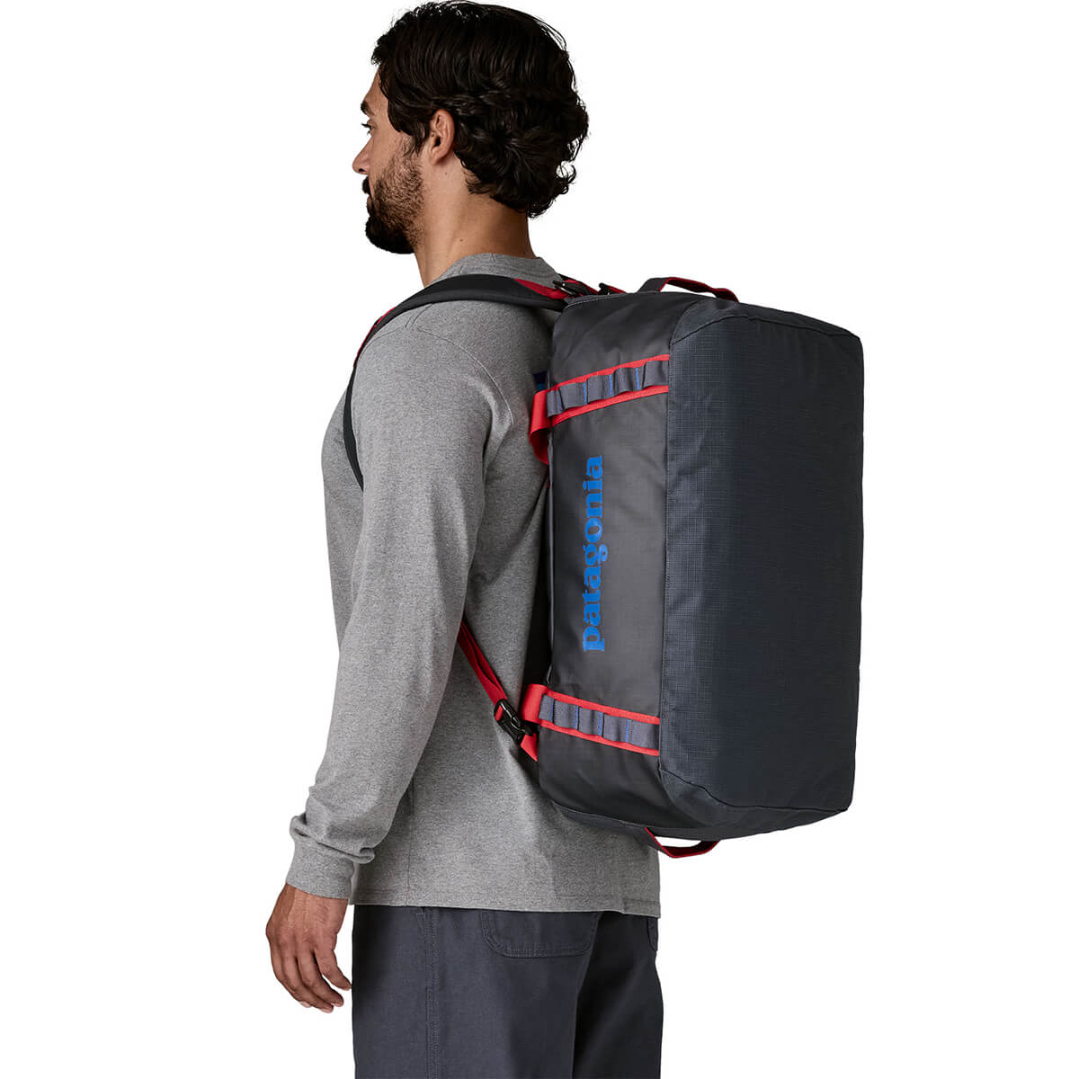 Smolder Blue w/Amanita Red carried by male model as backpack
