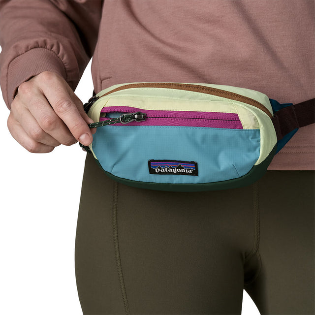 Patchwork/Snowmelt Blue worn as hip pack and closing zip