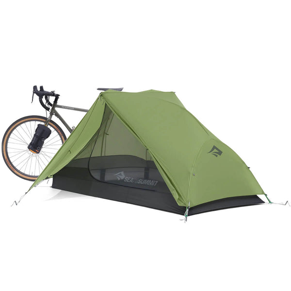Pitched with closed fly door open and with bike and tent attached behind