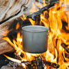 Billy hanging from branch hanging over a camp fire to boil water (no lid)