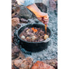 In use on embers, open and a stew being stirred