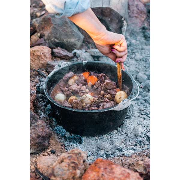 In use on embers, open and a stew being stirred