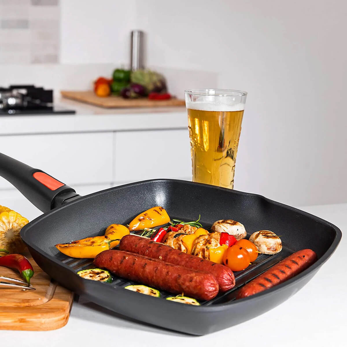 With sausages and veggies on a home kitchen bench