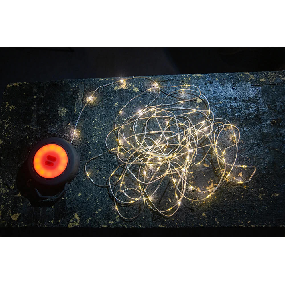 String light lit lying on ground beside the lantern lit with amber light