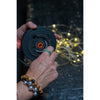 Crank handle on lantern in use to reel in the string lights