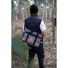 Slung crossbody and worn at back in the outdoors