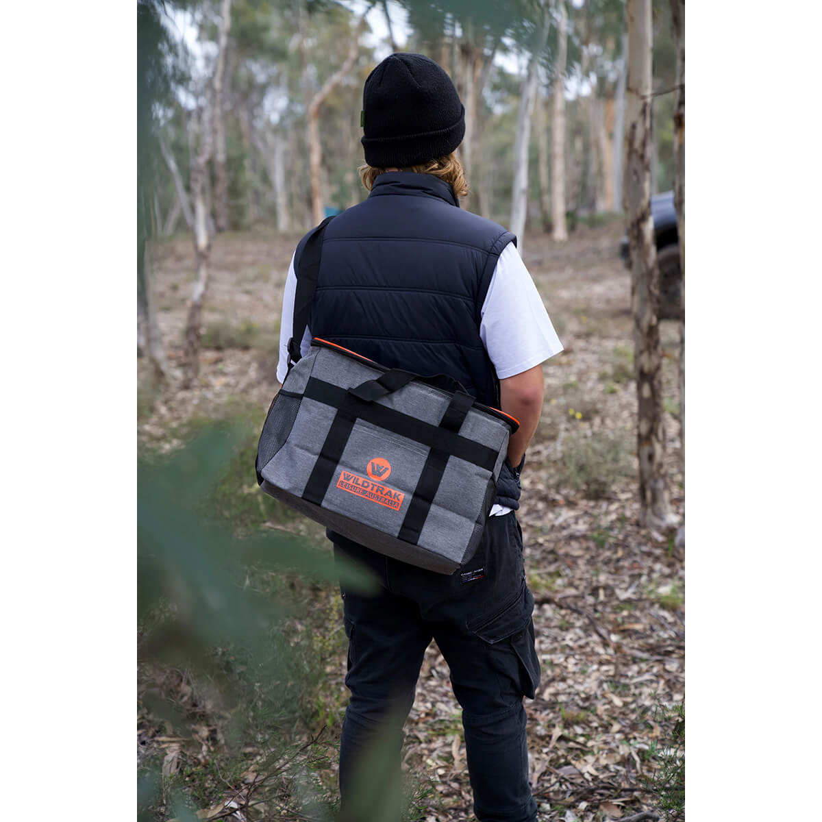 Slung crossbody and worn at back in the outdoors
