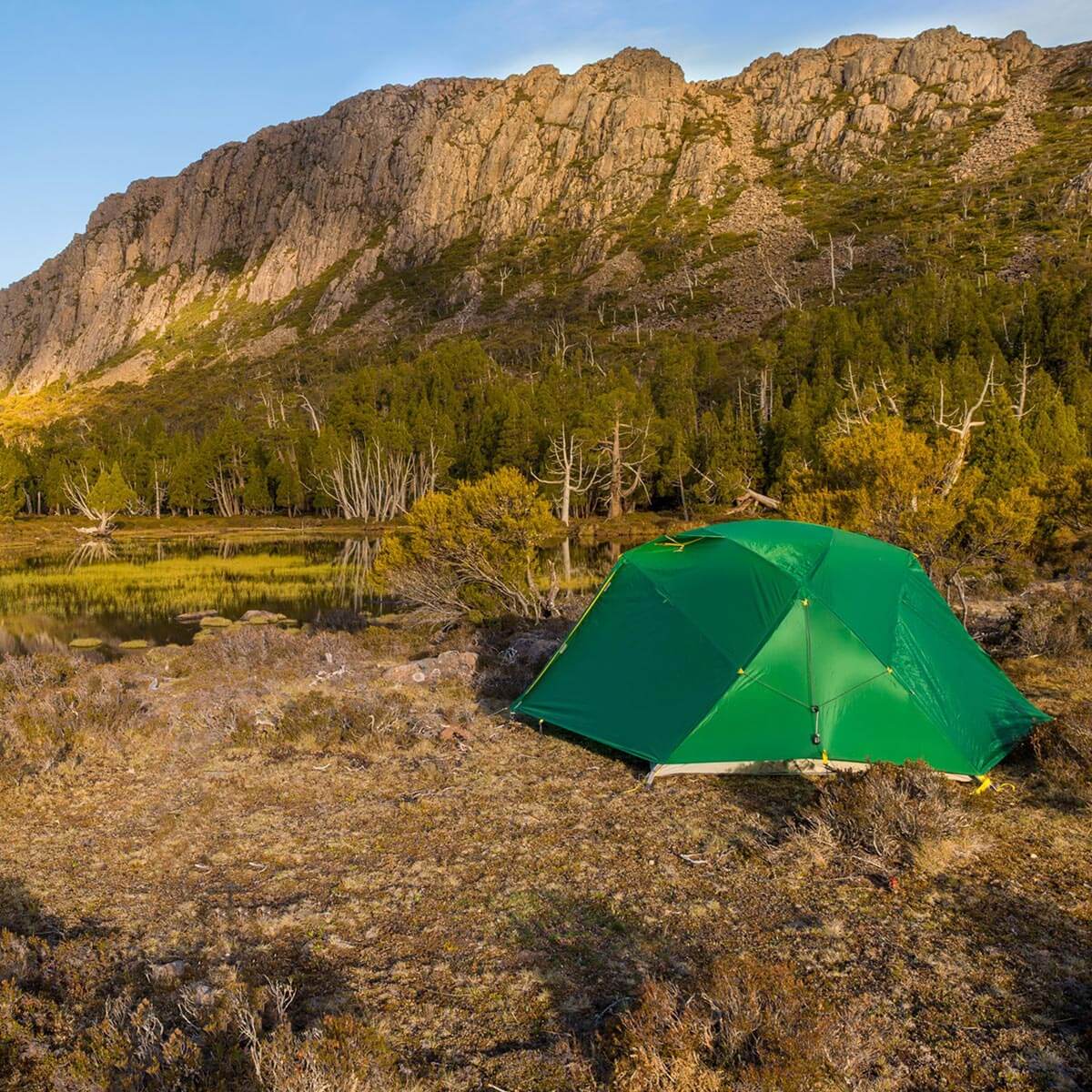 Set up in a a clearing by mountains and water