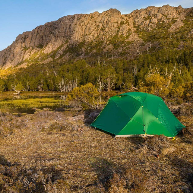 Set up in a a clearing by mountains and water