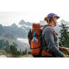 Filled system in side pocket of a pack on a trampers back in the mountains
