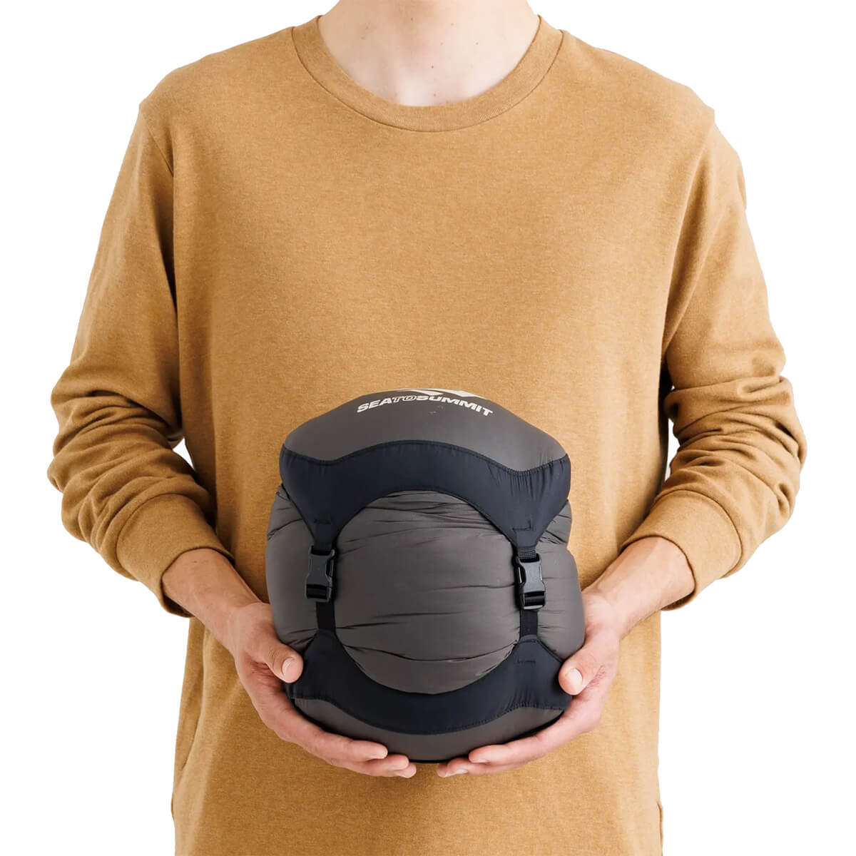 Packed in compression sack and held in hand as an idea of stowed size