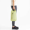 Model carrying 13-litre bag in Tarragon