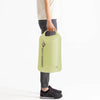 Model carrying 20-litre bag in Tarragon