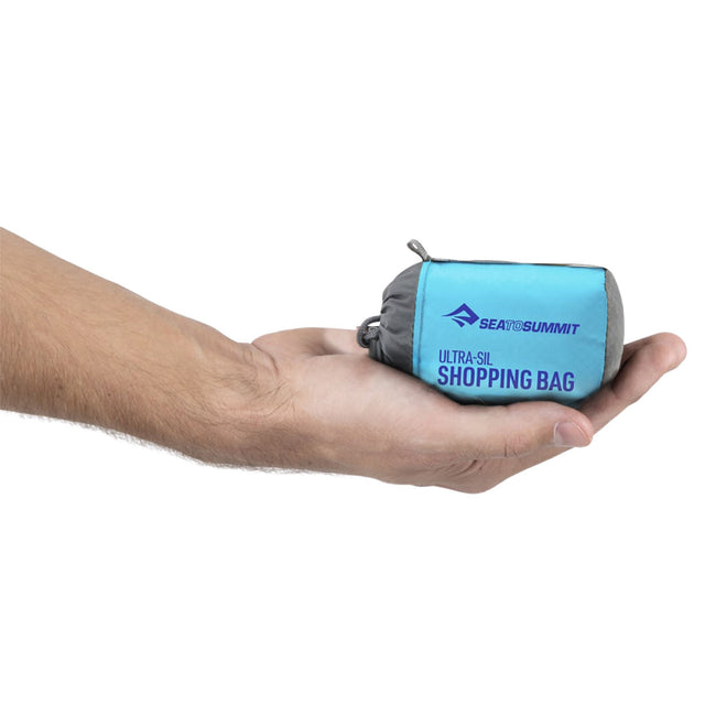 Packed and held in model's hand
